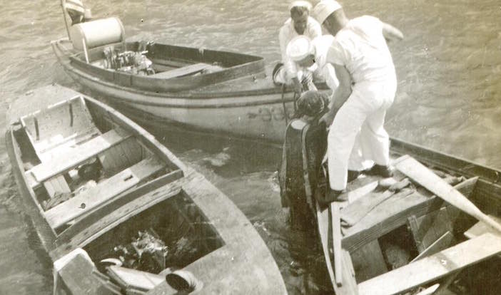American sailors pulling a victim from Smyrna harbor.
