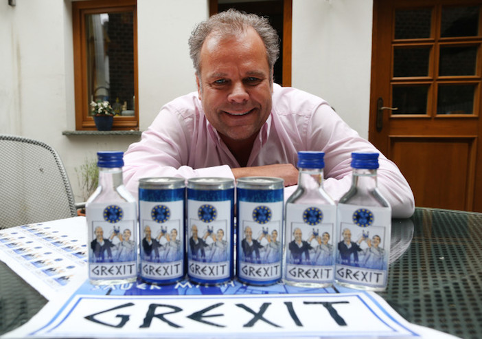 epa04816115 47-years old German businessman Uwe Dahlhoff poses behind products labeled with 'Grexit' in Hamm, Germany, 23 June 2015. Next week Dahlhoff wants to roll out a lemon vodka liqour with the brand name 'Grexit'. The term Grexit refers to the possibility that Greece leaves the Eurozone and combines Greece and exit.  EPA/INA†FASSBENDER