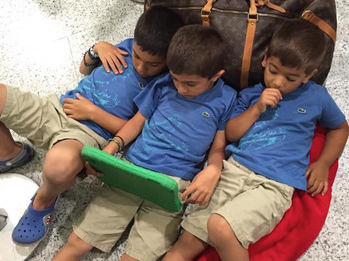 Photo by Despina Flouras-Anastasopoulos. Her three boys waiting at Athens airport for a SkyGreece representative to inform them of flight updates after Tuesday's cancellation.