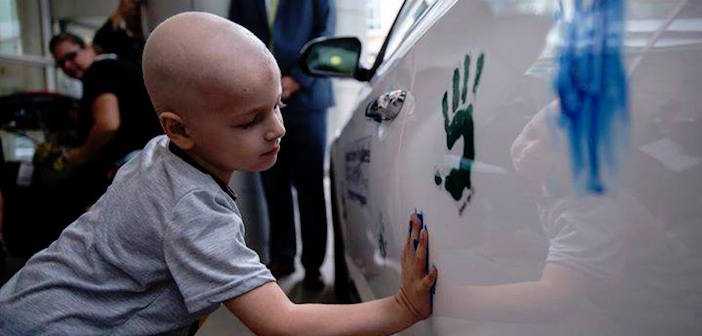Chris Ellis places his handprint during the Hyundai Hope on Wheels Check Presentation and Handprint Ceremony at the Comer Children's Hospital on the University of Chicago campus in Chicago, Ill., on September 4, 2014