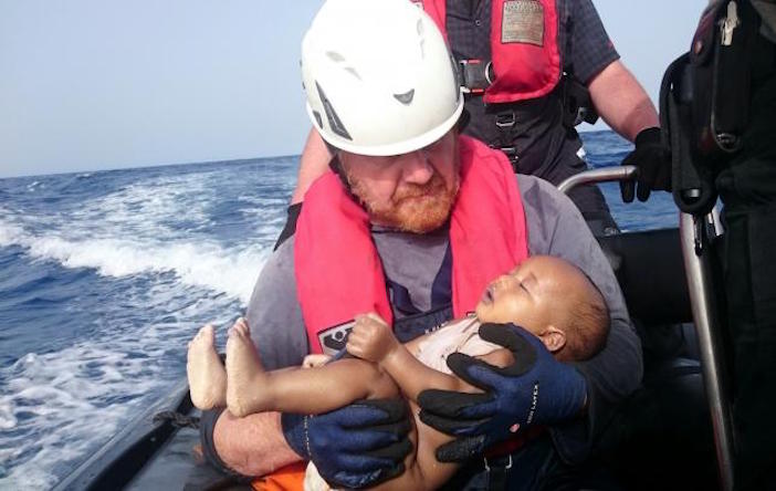 A German rescuer from Sea-Watch holds a drowned refugee baby, off the Libyan coast May 27, 2016. Photo by Christian Buettner/Eikon Nord GmbH Germany/Handout via Sea-Watch
