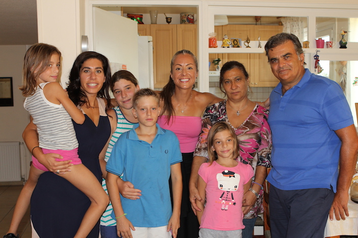 Voula, center, in pink, visiting with children and staff at SOS Children's Villages in Greece.