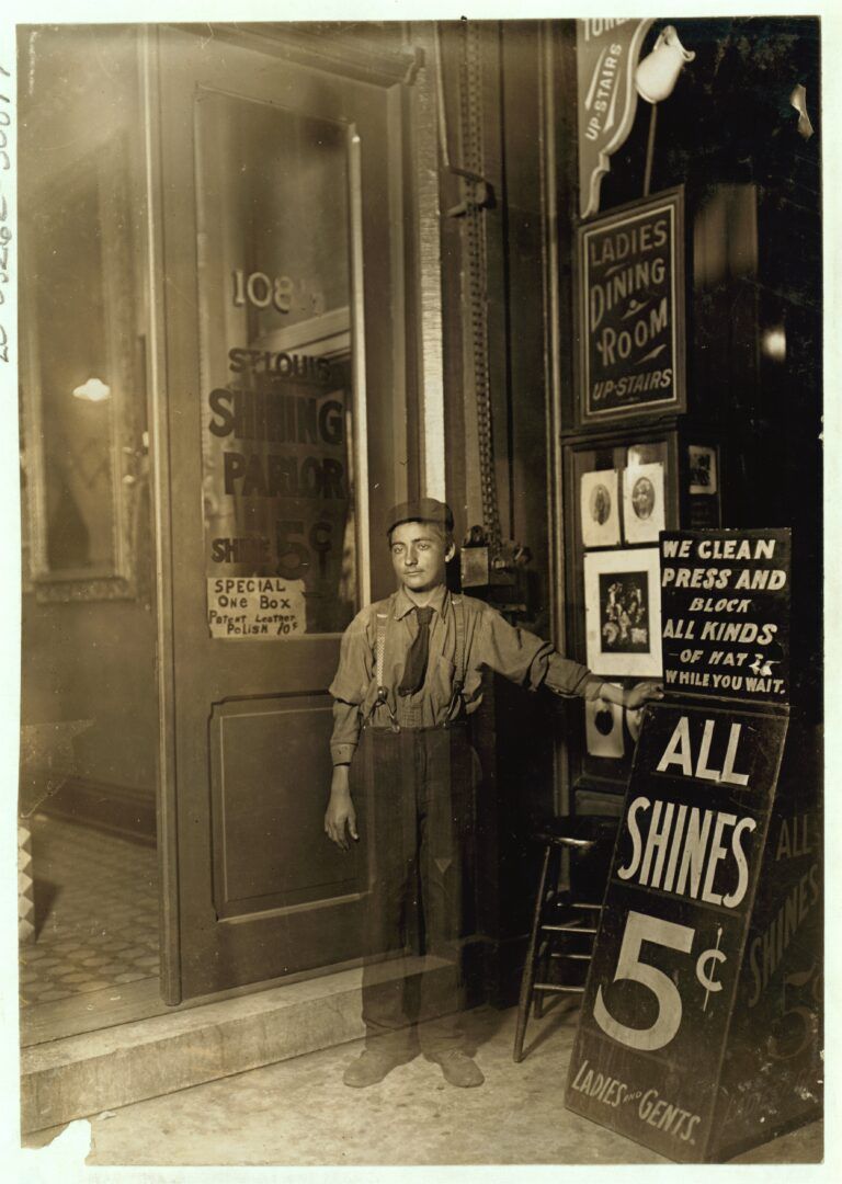 Young Greek bootblack at an Indianapolis shoe-shining parlor at 10 p.m. in 1908