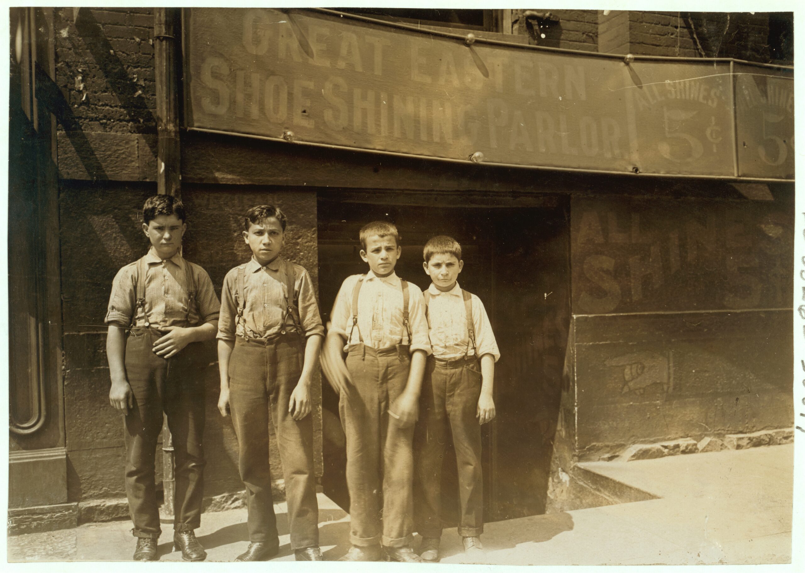 Four Greek bootblacks outside an Indianapolis shoe-shining parlor in 1908