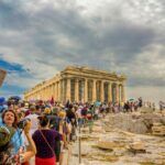 International visitors gather near the Parthenon at the Acropolis in Athens
