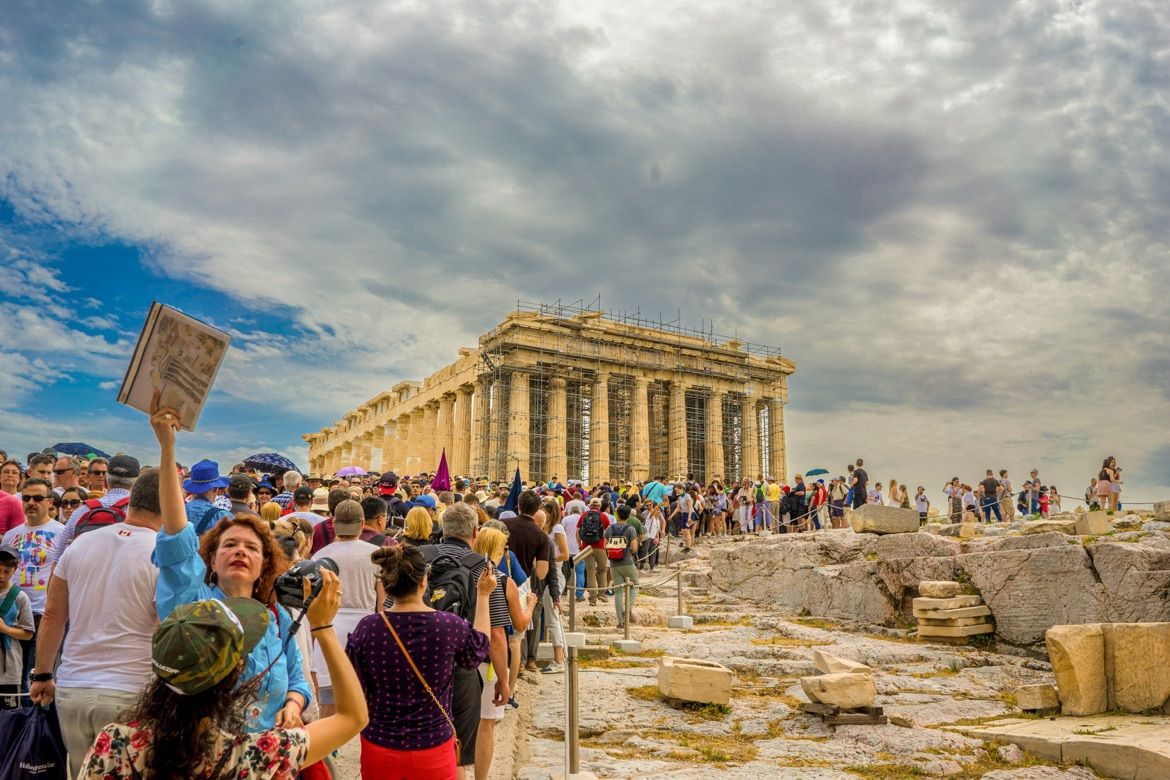 International visitors gather near the Parthenon at the Acropolis in Athens