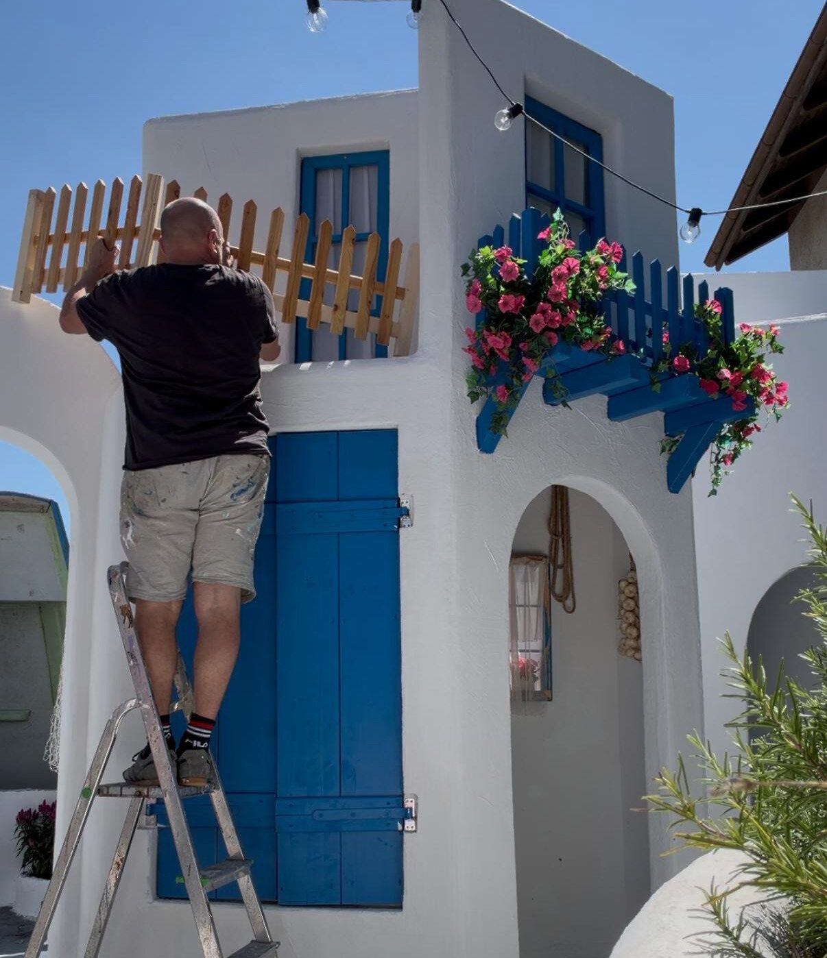 White Greek-themed facades under construction in the Scherrers' garden