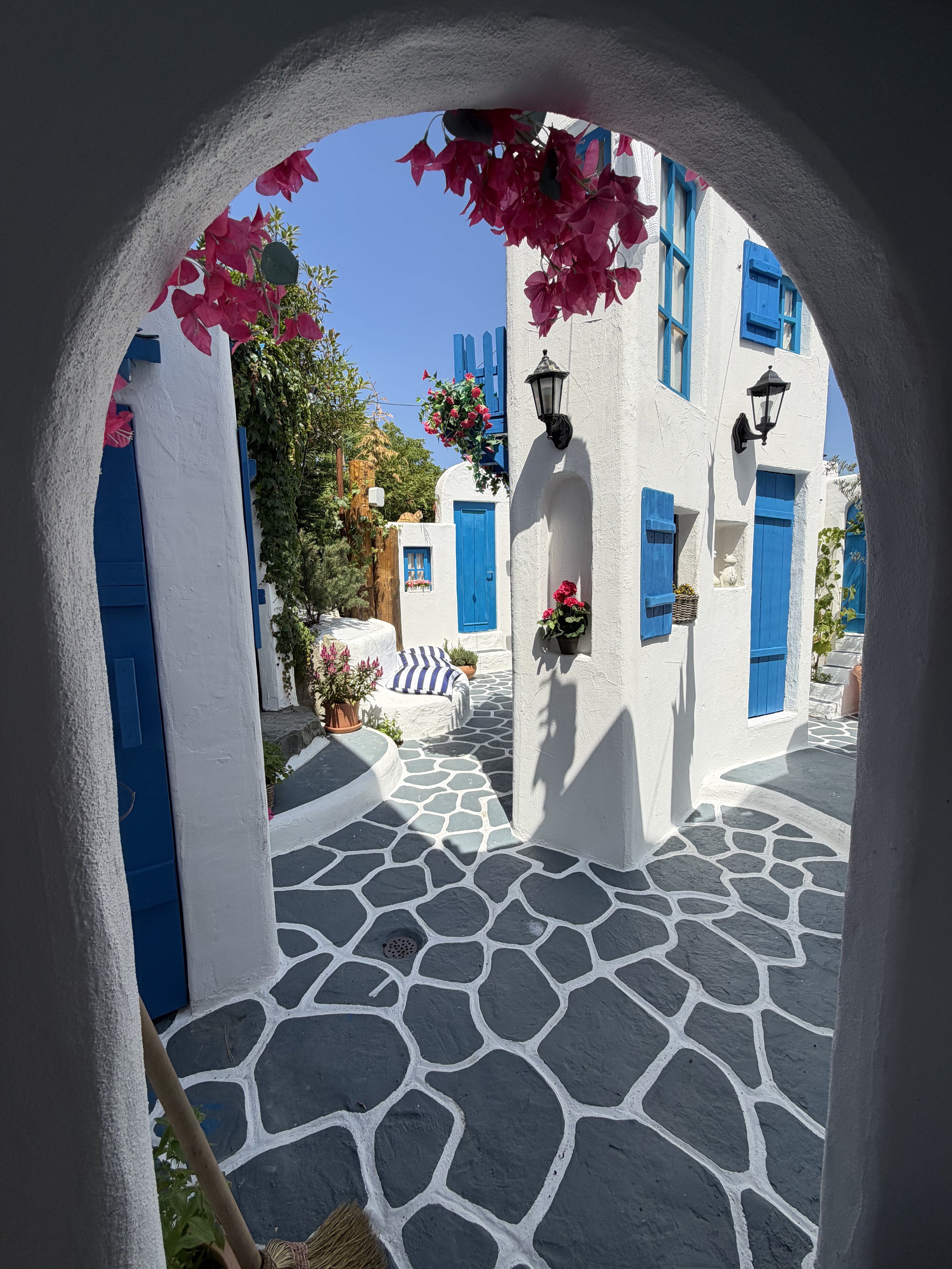 Whitewashed lane and blue doors inside Little Greece in Switzerland