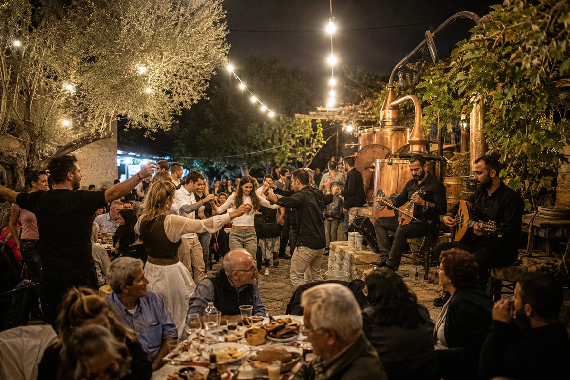 Illustrative image of a traditional Cretan kazani celebration with dancing, live music and a copper still.
